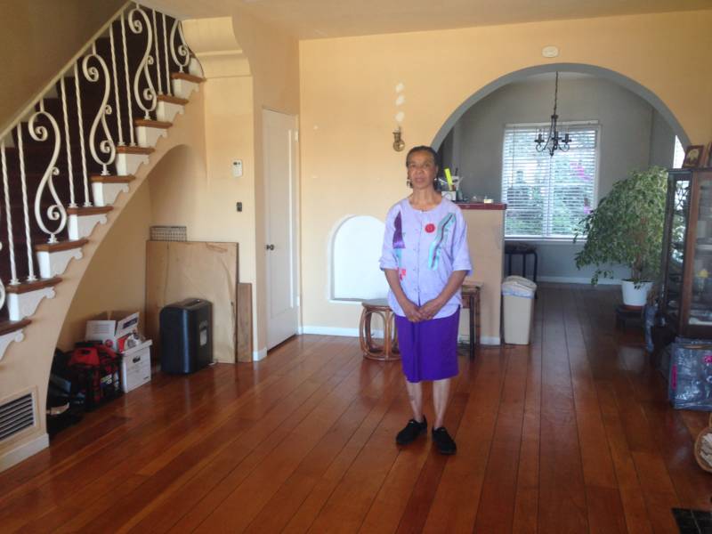 Karen Francisco stands in her bare front room. She says she has been preparing to leave her fourplex, which she owns, because the costs to maintain it are too high.