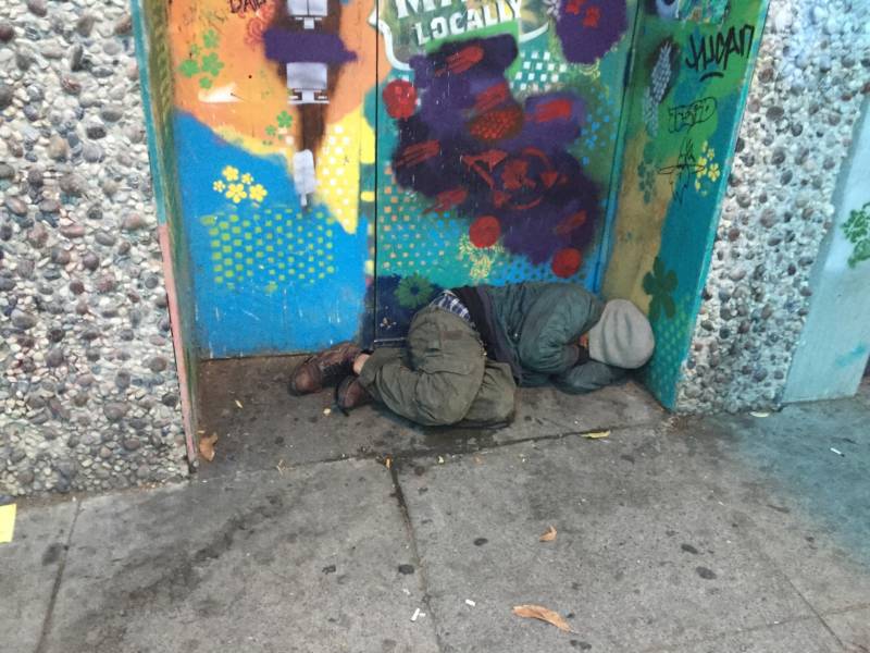 A homeless man sleeping in a doorway in San Francisco.