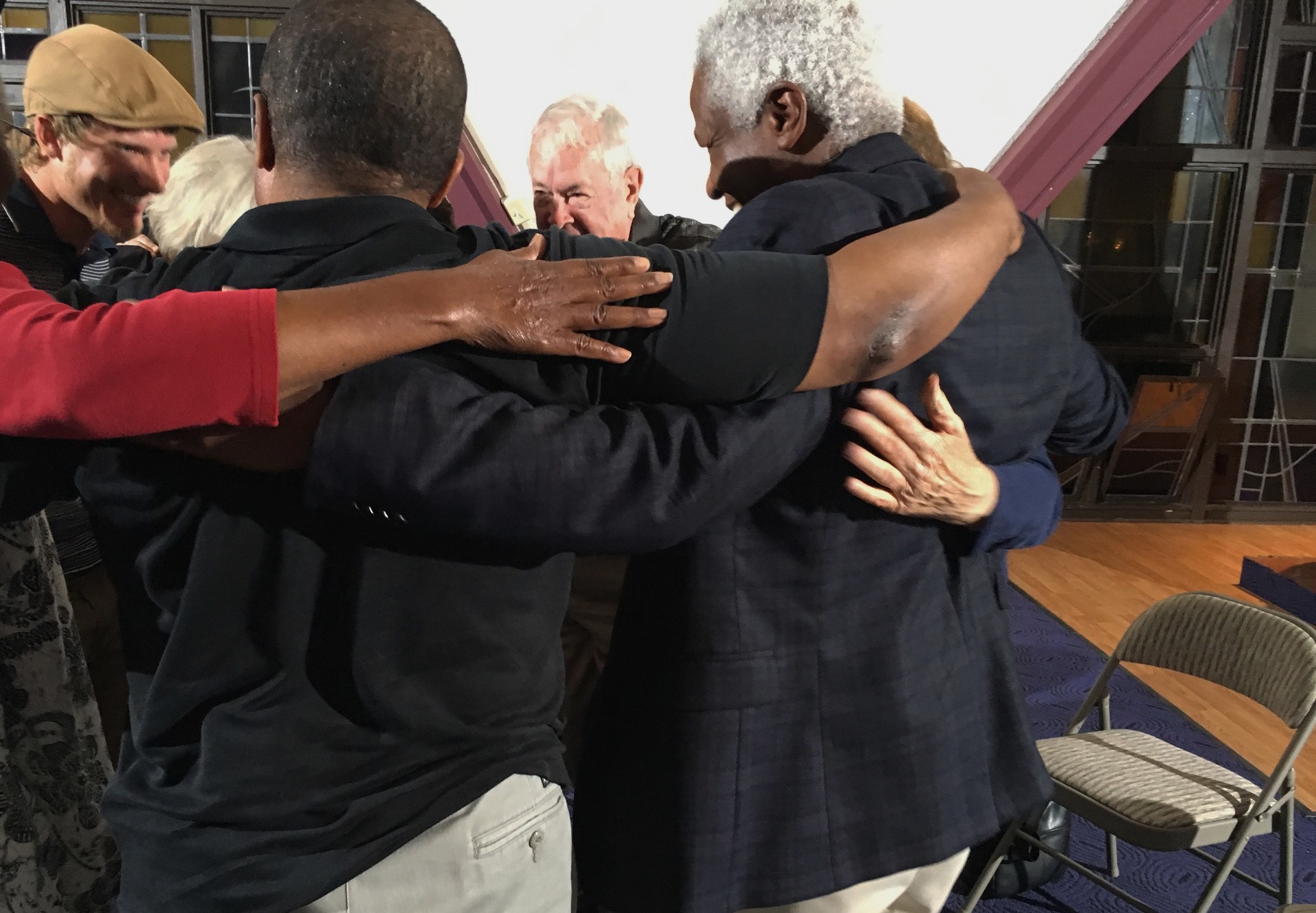 Racists Anonymous members hug after a meeting at a chapel in Sunnyvale. The diverse group includes a psychiatrist, preschool director, landscaper, and retired business executive.
