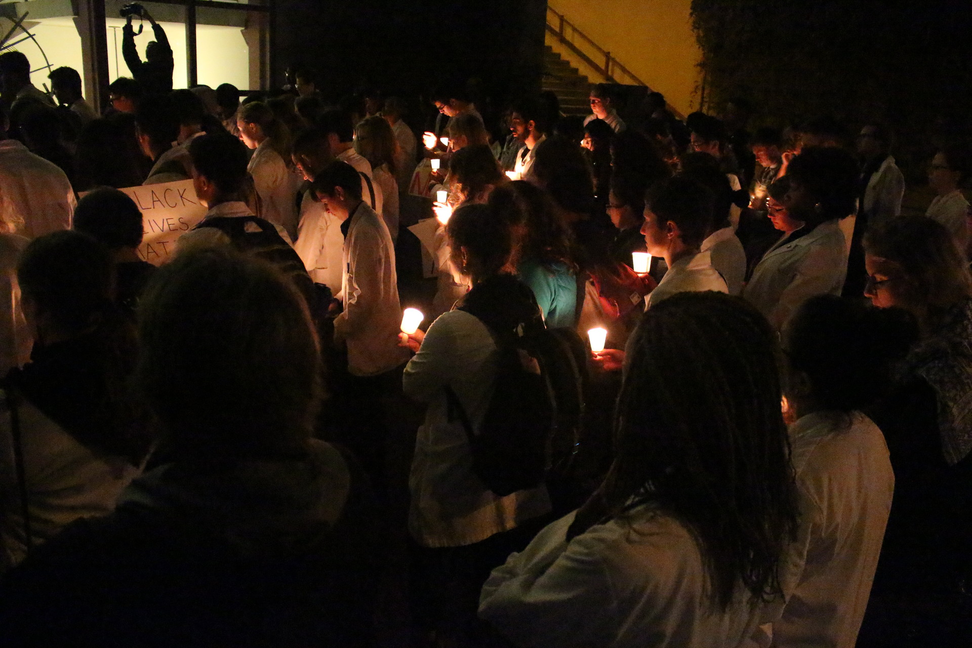 Future doctors, nurses, pharmacists and dentists attend a vigil in San Francisco on Sept. 27, 2016 for recent African American victims of fatal police shootings. Organizers of the White Coats For Black Lives vigil say health care professionals must act against racism in health care and elsewhere in society. 