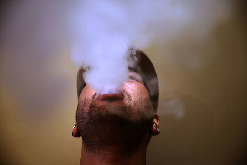 A man blows vapor from an e-cigarette at a vape lounge in San Francisco.