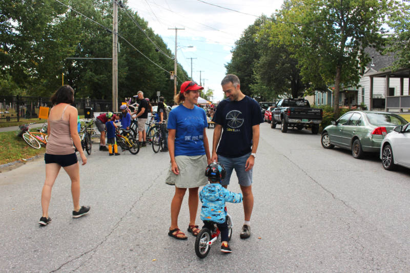 O'Neill and fellow bike lane advocate Brendan Hogan stand with Hogan's son George on a blocked off street during Open Streets in Burlington.