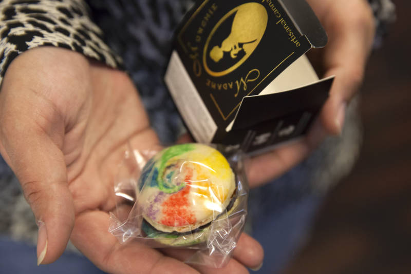 A staff member at the Green Door dispensary in San Francisco, California holds a cannabis-infused macaroon by Madame Munchie. 
