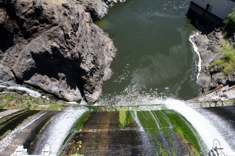 Water spills down the mossy face of the Copco 1 Dam, on the Klamath River outside Hornbrook. 