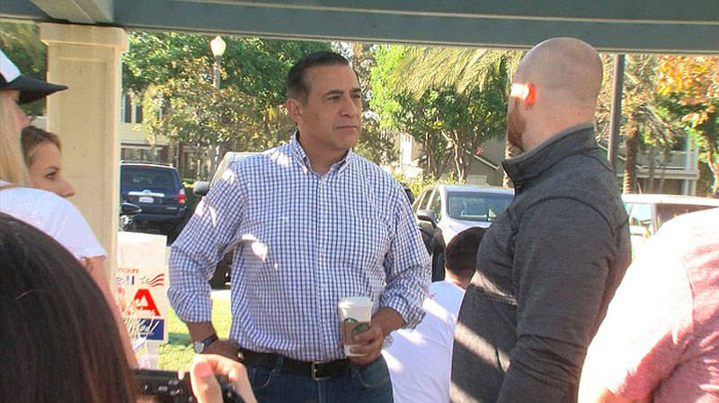 U.S. Rep. Darrell Issa reaches out to volunteers while campaigning in Orange County, Oct. 1, 2016. 
