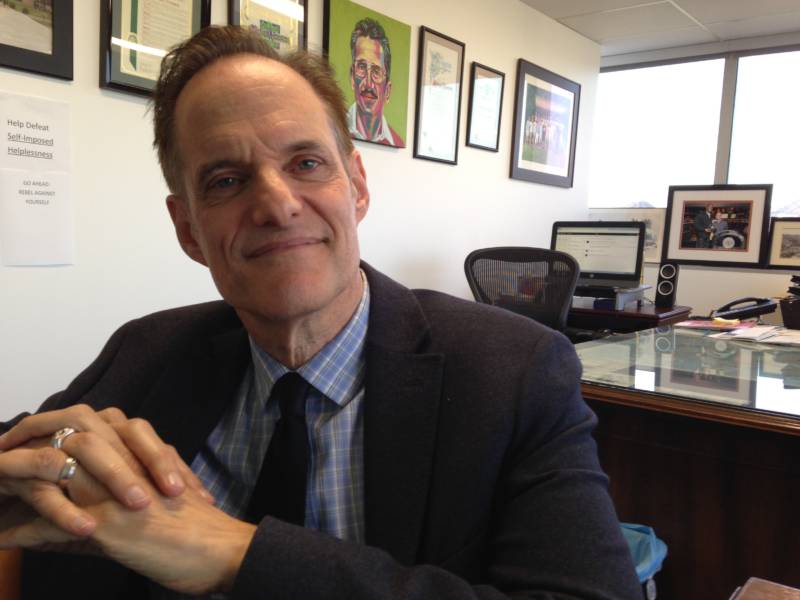 Michael Weinstein, president of the AIDS Healthcare Foundation, in his office in Los Angeles. Behind him is a painting of Chris Brownlie, who worked with Weinstein to found the first AIDS hospice in LA.