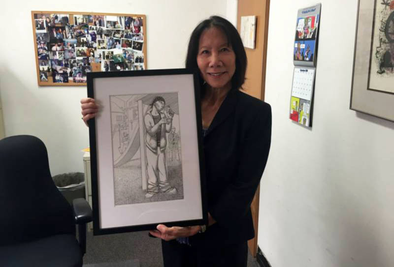 Patricia Lee, managing attorney of the San Francisco Public Defender’s Juvenile Division, holds artwork that she feels demonstrates the challenges many of her clients face. 