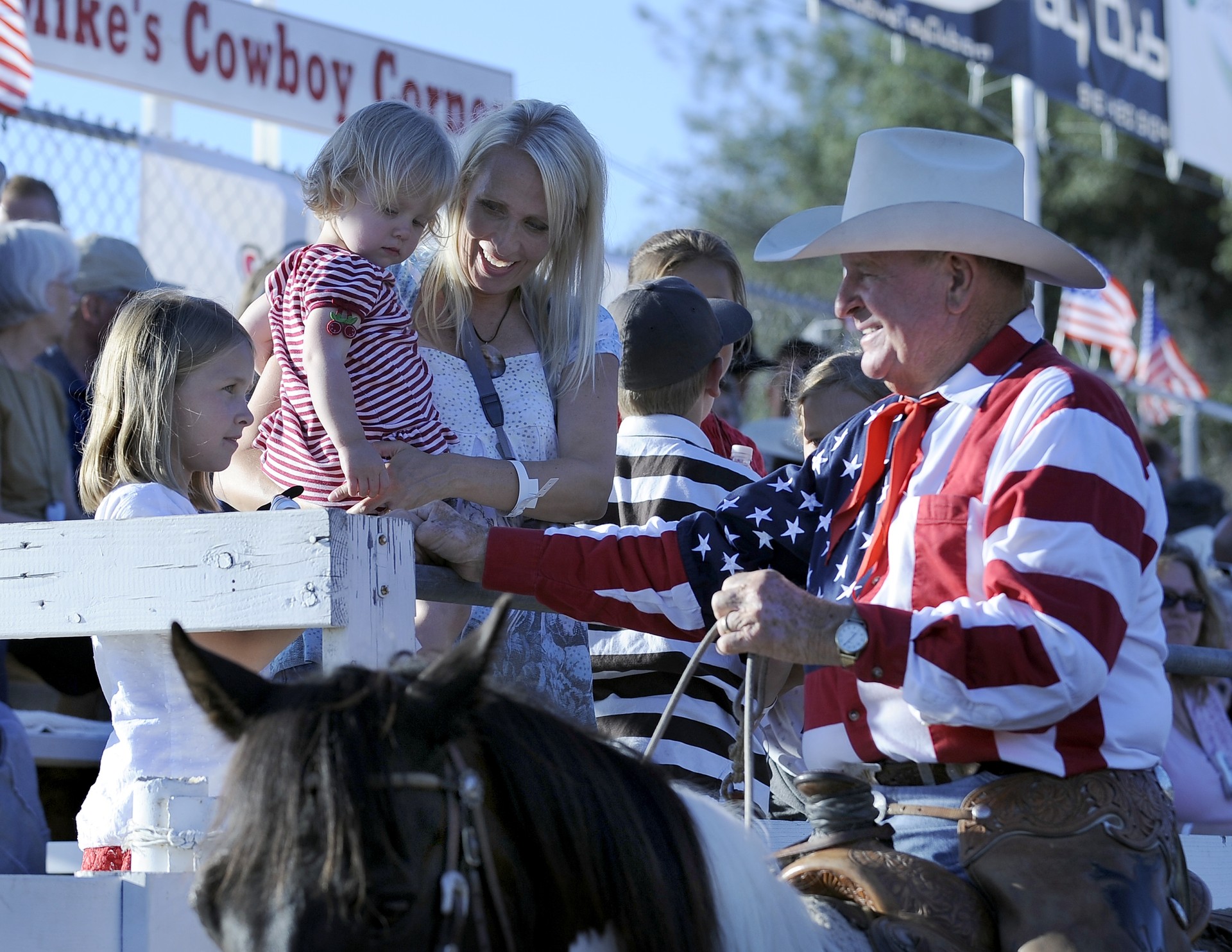 Cotton Rosser greets children in the stands at the Folsom Pro Rodeo in Folsom, CA. 