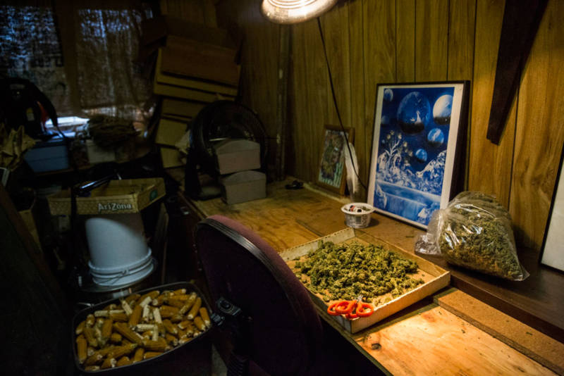 Terri sat in an office chair in this cramped shack, trimming marijuana buds. She and three other trimmers were paid $200 for every pound. They wore aprons and tracked their work with paper and pencil.