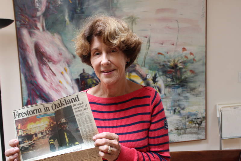 Margaret Schaefer holds a news clipping saved from the day after the East Bay Hills Fire.