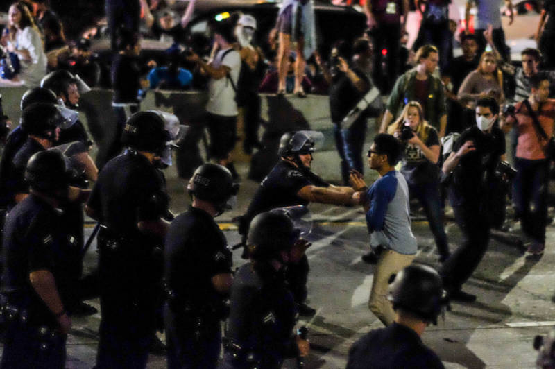 Police arrest demonstrators after they shut down the 101 Freeway in Los Angeles on Wednesday night.