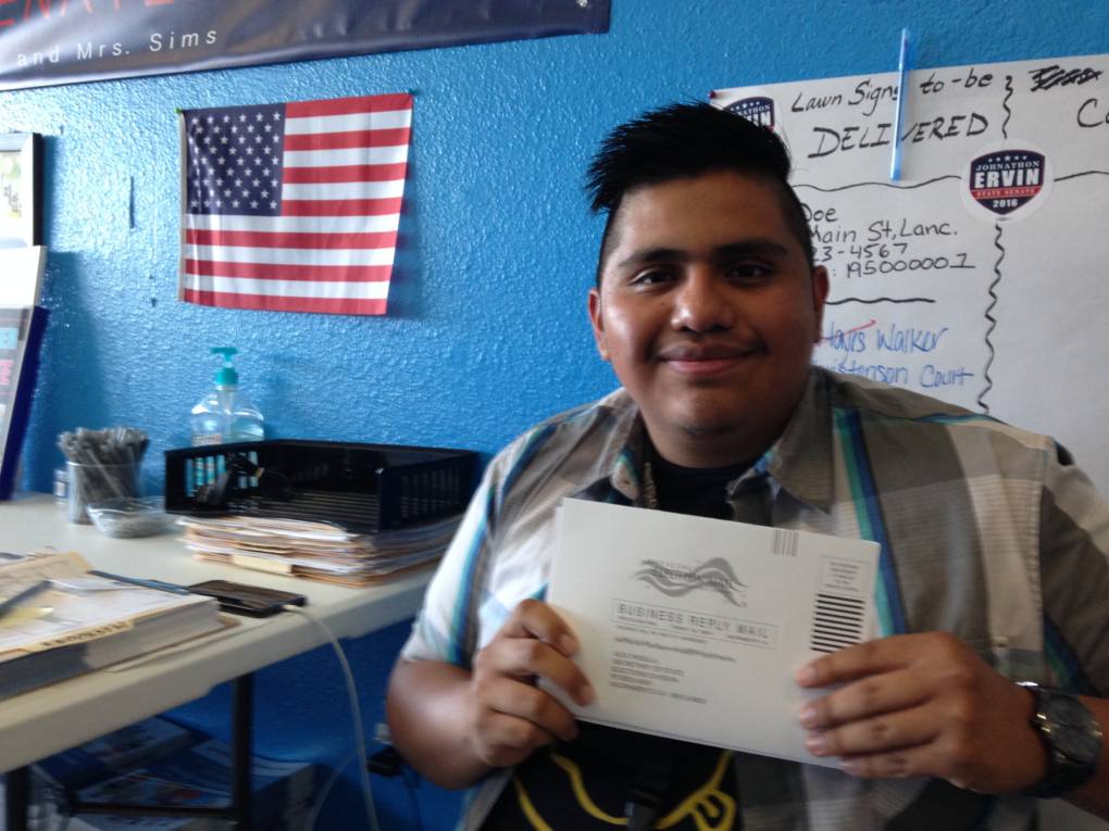Chris Martinez, 20, holding his completed voter registration form.