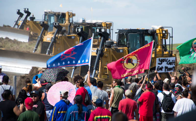 Members of the Standing Rock Sioux Tribe and their supporters opposed to the Dakota Access Pipeline (DAPL) confront bulldozers working on the new oil pipeline near Cannon Ball, North Dakota. Donald Trump has surrounded himself with climate change deniers, oil industry executives and lawmakers from states like North Dakota who are eager to expedite production of oil, gas and coal.