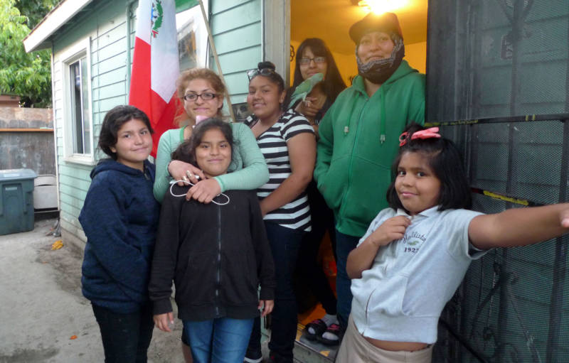 Rocio Tafoya (in green) with some of her children at the East Salinas apartment they rent.