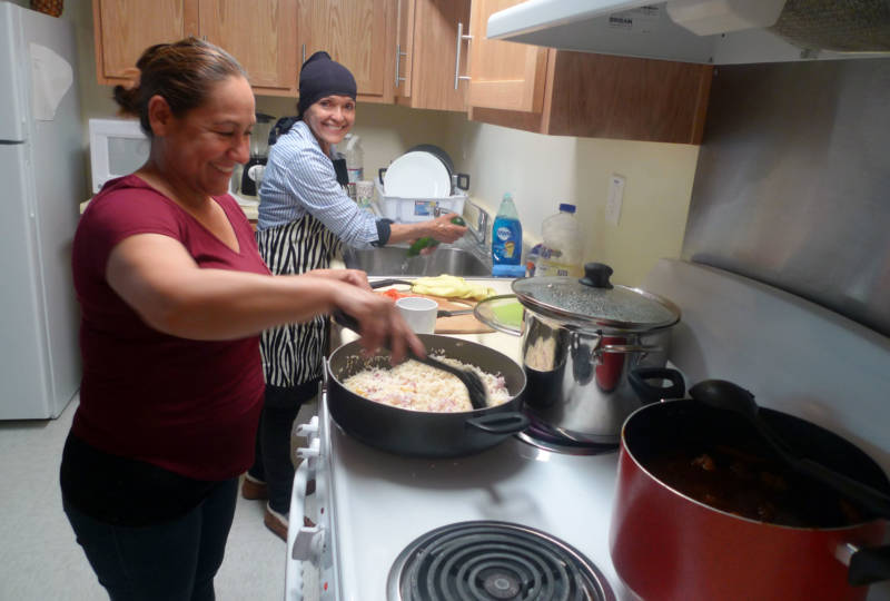 Maricela Williams and Lucia Jacquez cook at their apartment built by Tanimura and Antle.