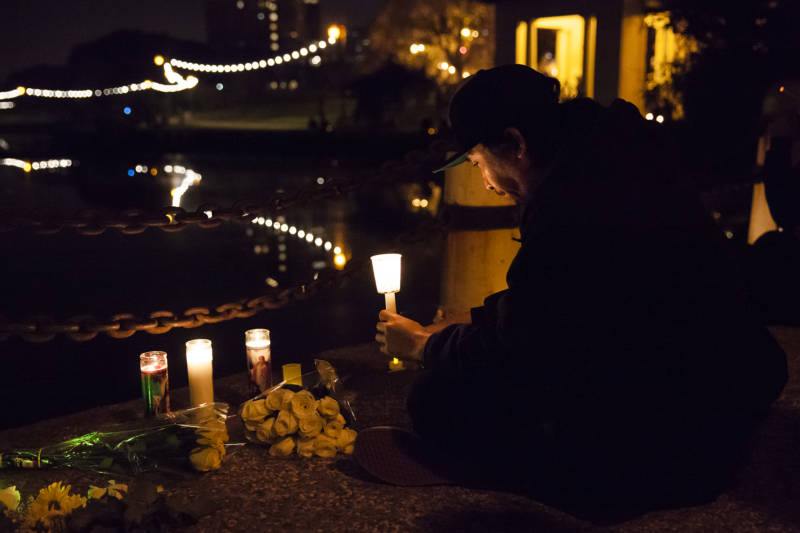 Holi Barahati lights a candle during the candlelight vigil at Lake Merritt on Tuesday, December 5, 2016 in Oakland California. Barahati lost three friends in the Ghost Ship fire. “I’m just still processing,” say Barahati.