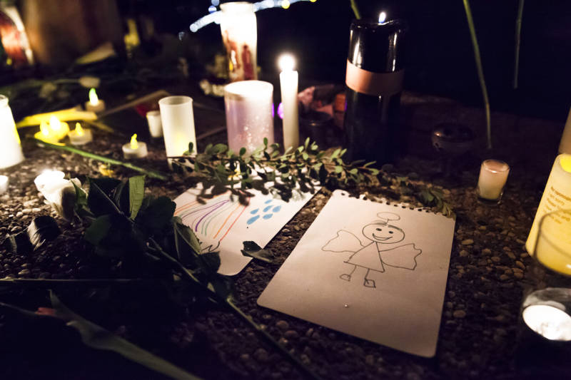 Small drawings were left at the memorial, tucked among candles and flowers.