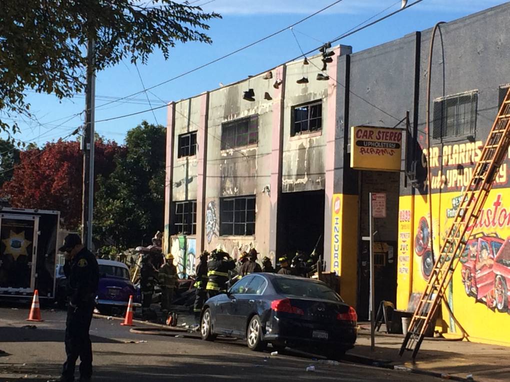 Oakland, California, firefighters inspect a warehouse on December 3, 2016, where a fire during a rave party killed 9 people on December 2. Nine people were killed and 25 missing after a huge blaze broke out during a rave party near San Francisco held in a cluttered, maze-like warehouse for artists, known as "Oakland Ghostship," fire officials said Saturday. 