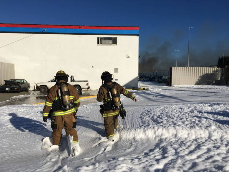 Firefighters used foam to suppress blaze at Richmond auto salvage yard Friday morning.