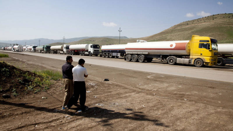 Oil trucks line up in April 2013 at the Bazian refinery near the city of Sulaymaniyah in the semi-autonomous Kurdish region of northern Iraq. ExxonMobil was one of several oil companies to negotiate with the regional government, despite opposition from Baghdad and the United States.