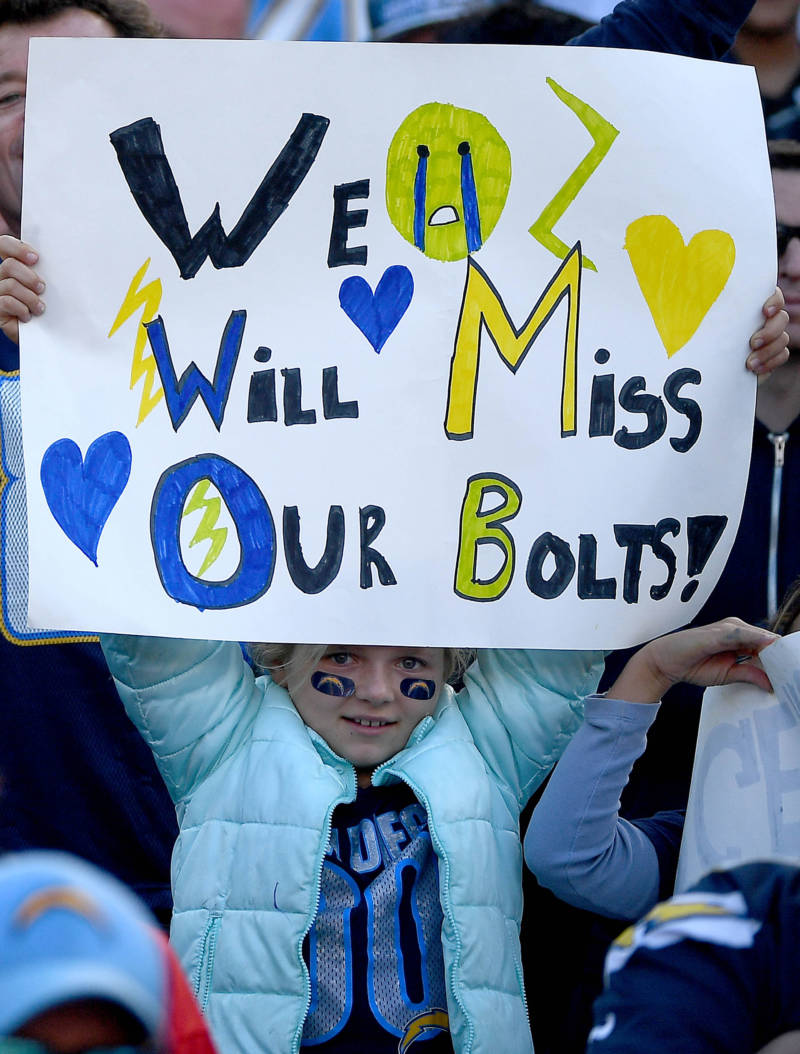 A young fan of the San Diego Chargers holds a sign en route to the Charger's 37-27 loss to the Kansas City Chiefs at Qualcomm Stadium on January 1, 2017.