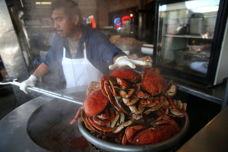 A cook at Nick's Lighthouse in San Francisco prepares Dungeness crab.