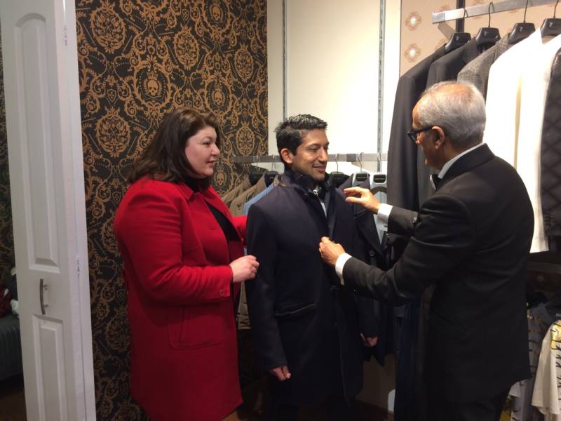 Juan Hernandez looks for a coat to wear to the presidential inauguration at Bossini USA in Santa Clara.