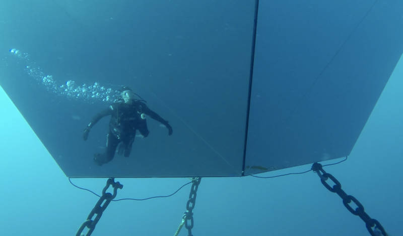 A diver is reflected in Doug Aitken's 'Underwater Pavilions' installation.