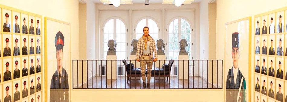 Fashion designer, Wolfgang Joop, in his AMAZING Berlin mansion, flanked with Collier Schorr photographs.