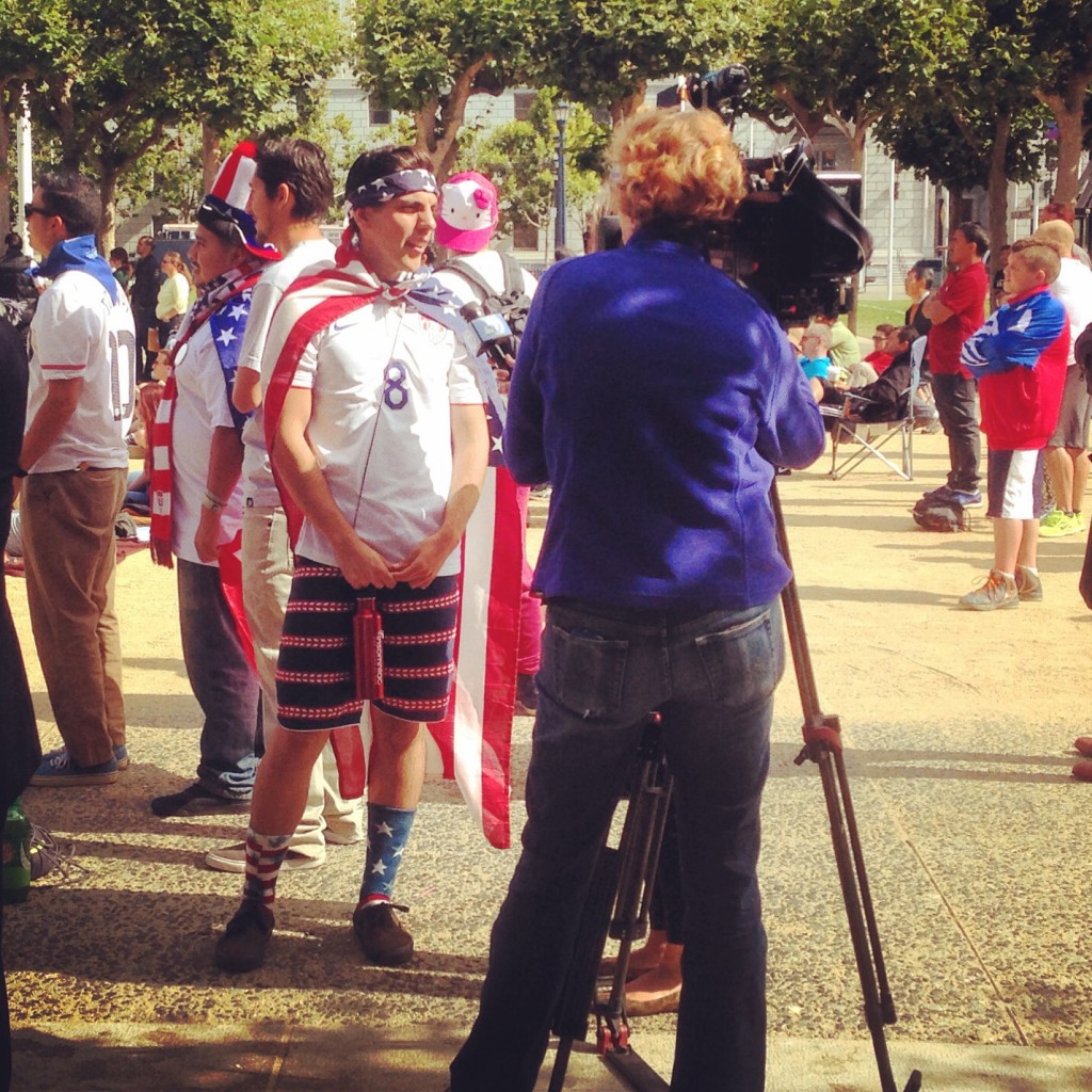 Local news goes for the obvious interview ahead of the US game. Civic Center Plaza (July 1, 2014)