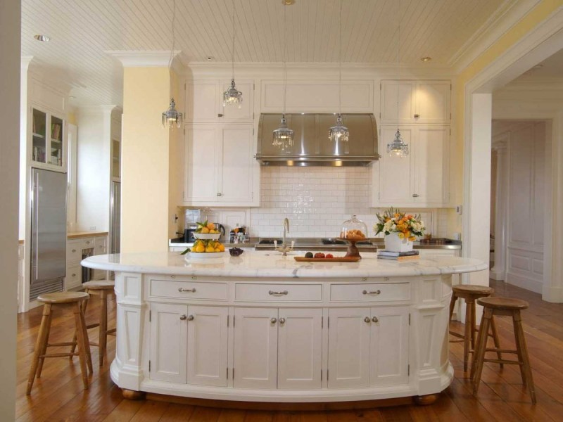 the-kitchen-has-a-large-island-and-shiny-light-fixtures