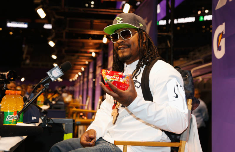 Marshawn Lynch eats Skittles as he addresses the media at Super Bowl XLIX Media Day in 2015.