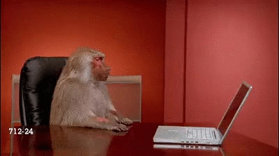 monkey pushes computer off table gif