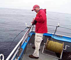 Producer Chris Bauer fishes for squid and tries to stay on his feet.