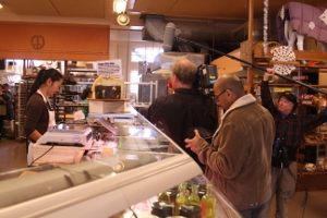 QUEST production crew filming inside the Cheese Board in Berkeley.