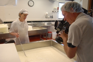 Cameraman Blake McHugh films artisan cheesemaker Maureen Cunnie in the early stages of making the Red Hawk washed rind cheese.