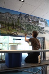 Bakker working on the wildlife mural at West Valley College - photo by Molly Schrey