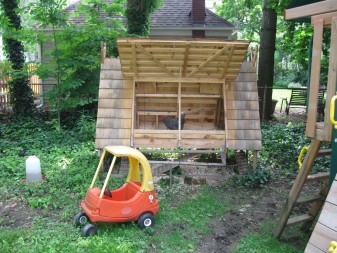 Wilson's chicken coop shares backyard space with his kids' swing-set and other toys.
