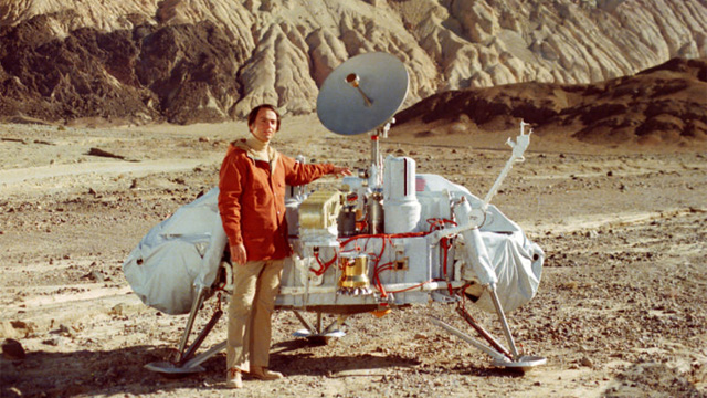 Carl Sagan Poses with Model of Viking Lander