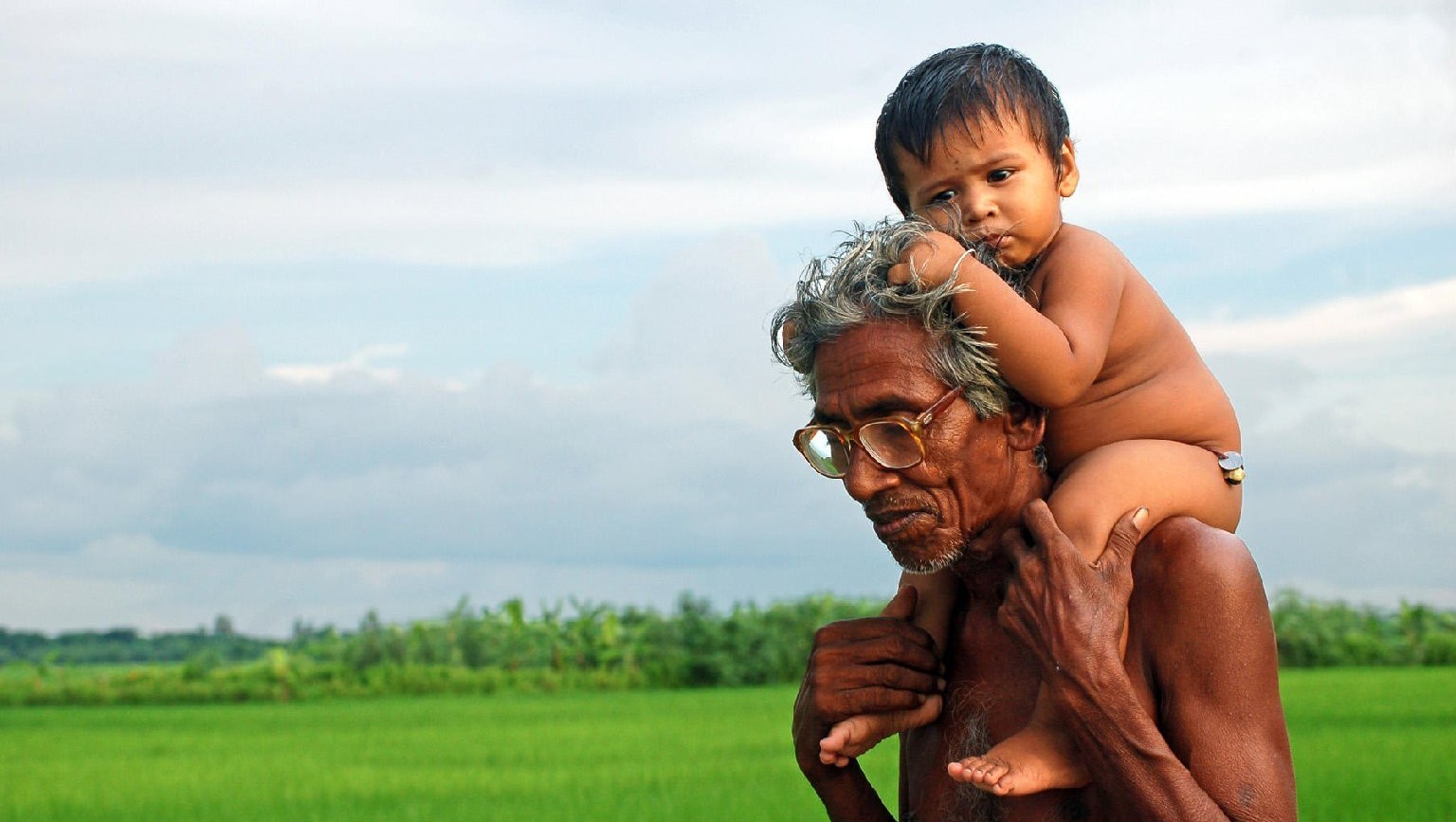 A grandfather in India enjoys the company of his grandson. 