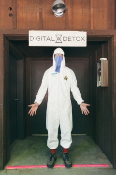 A counselor in a hazmat suit ready to search campers for digital devices. Photo: Daniel N. Johnson.