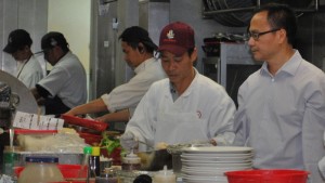 Willy Ng, right, in the kitchen of his Daly City restaurant Koi Palace.