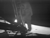 Neil Armstrong (1930–2012), commander of NASA's Apollo 11 mission, descends the ladder of the Apollo Lunar Module to become the first human to step foot on the surface of the Moon. 