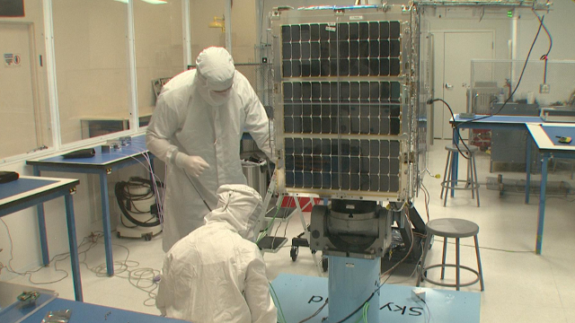 Technicians at Skybox Imaging work on a satellite in a clean room at the company's headquarters in Mountain View. Image by Blake McHugh.