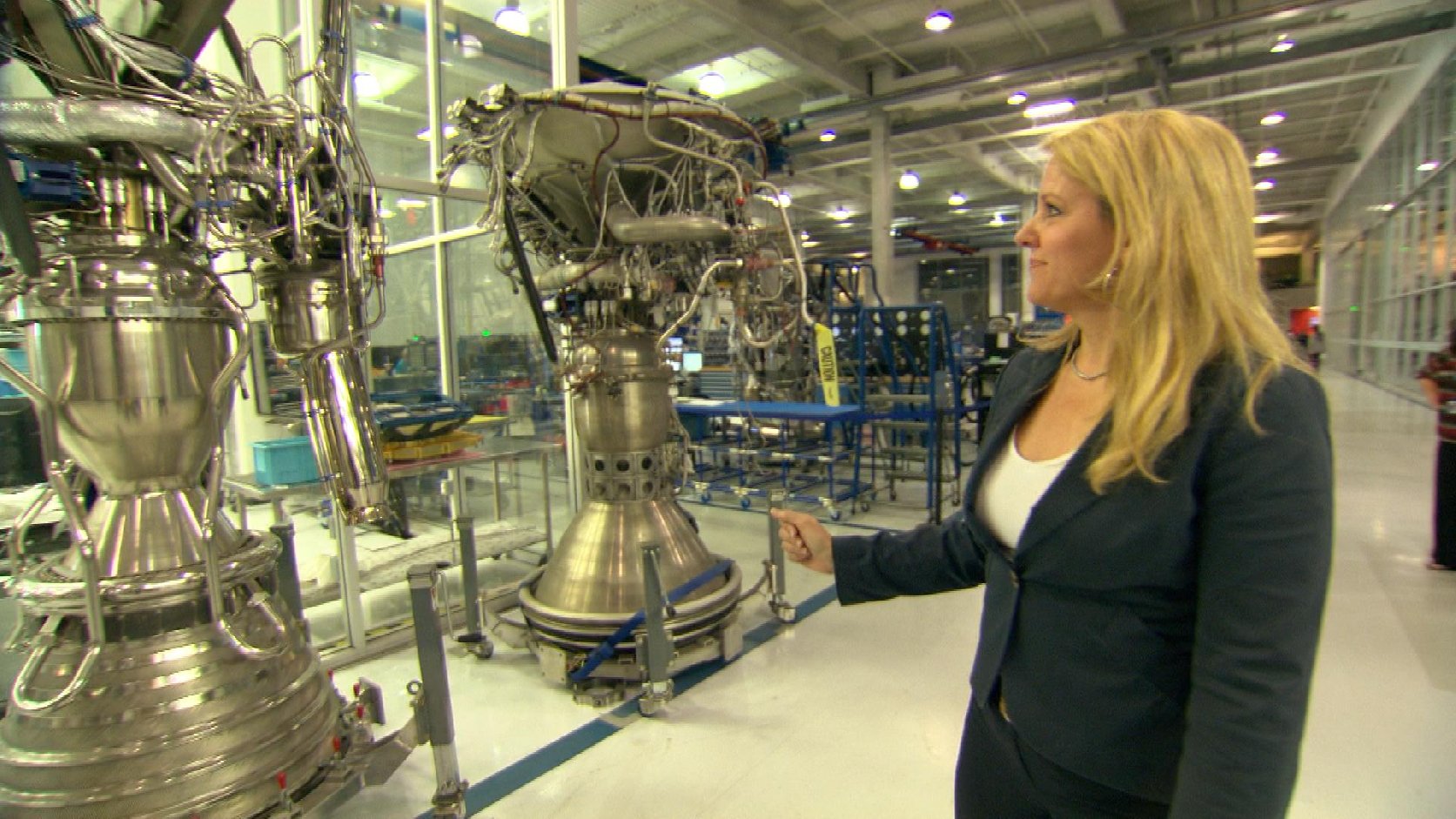 Gwynne Shotwell, President and COO of SpaceX, shows off rocket engines being built at the company's headquarters near L.A. Image by Jayme Roy