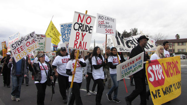 About 150 people marched to Pittsburg city hall on Saturday, protesting a proposed oil terminal. (Molly Samuel/KQED)