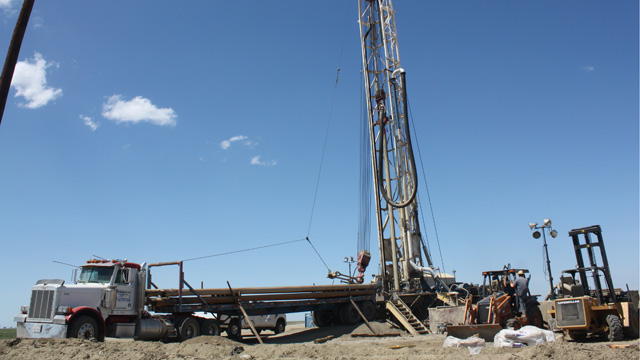 Drillers are bringing in large rigs like this one from all over the west, to drill deeper wells in the quest for water. (Sasha Khokha/KQED)