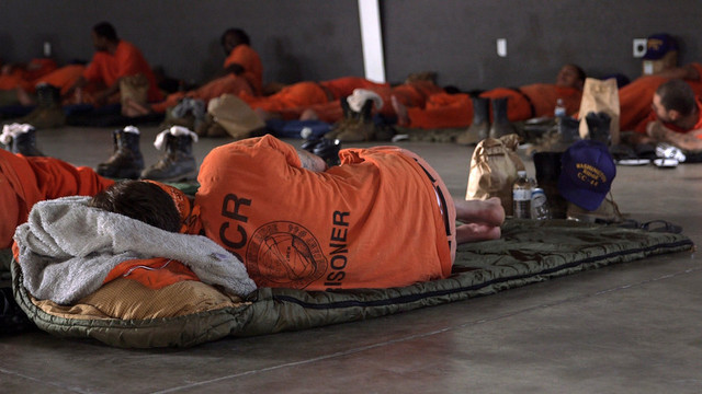 An inmate firefighter crew sleeps at a base camp in Redding after a 24-hour shift. (Adam Grossberg/KQED)