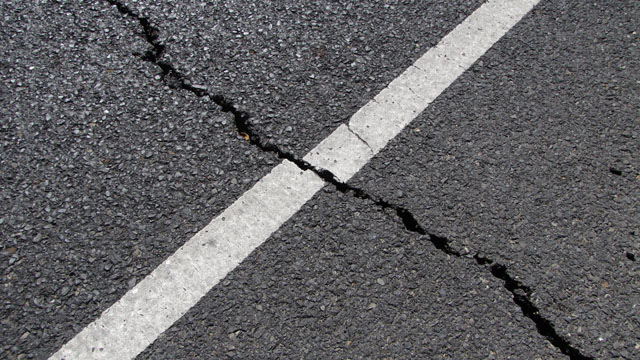 Highway lane markings offer highly visible clues to geologists looking for evidence of lateral slip. Scientists noted this fracture on Redwood Road, on Napa's west side. (Craig Miller/KQED)