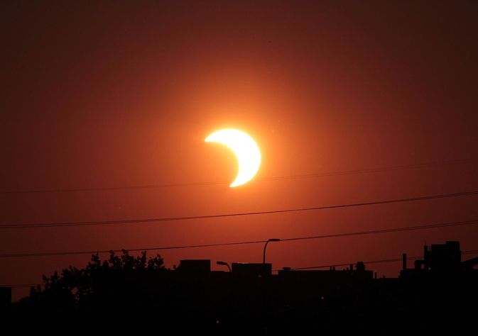 A partial solar eclipse occurs when the moon obscures only part of the sun from Earth's view. (T. Ruen/NASA)